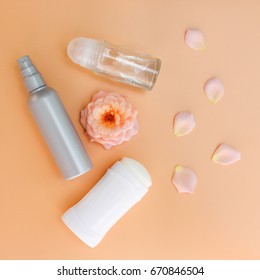 Different deodorants on beige background. Top view.