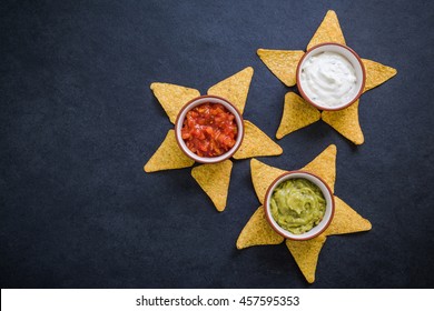 different dips and sauces for nachos, food background