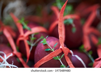 Different Easter Eggs dyed in Natural ingredients, such as onions, tied with ribbon and decorated with thyme . High quality photo