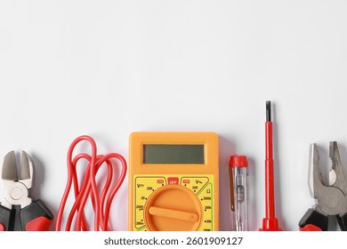 Different electrical tools on light background, flat lay. Space for text