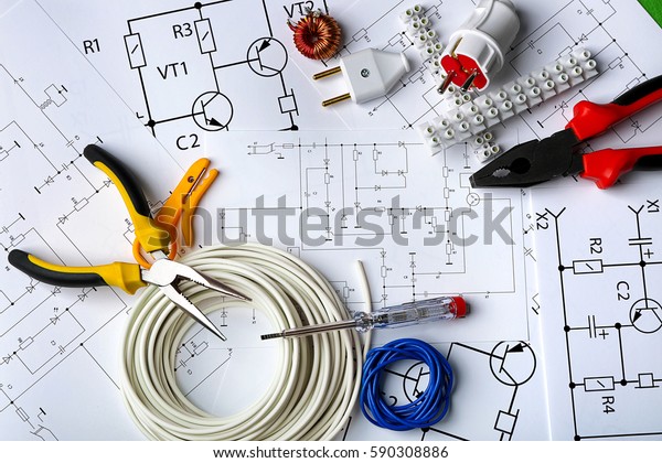 Different electrical tools on paper circuit\
drawing background