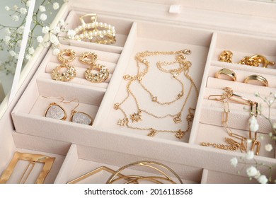 Different elegant bijouterie in pink jewelry box  closeup