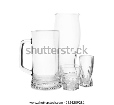 Different elegant empty glasses isolated on white