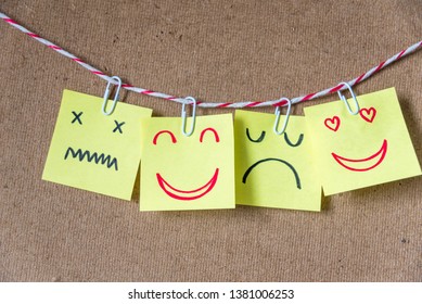 Different emotion faces drawing on sticky notes on blank board, positive attitude and happy concept. - Shutterstock ID 1381006253