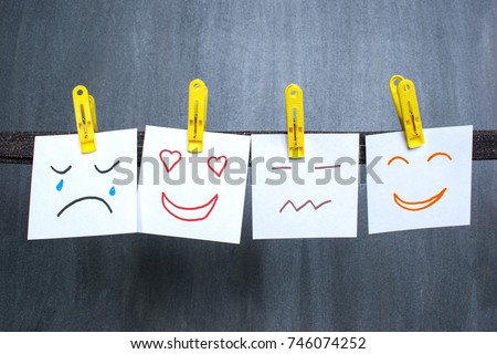 Different emotions drawn on notes, dark background. 