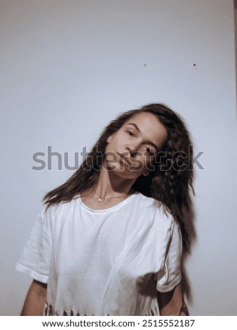 barefoot young woman sitting barefoot in a window frame