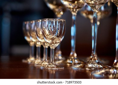 different empty glasses standing in a row on the bar counter