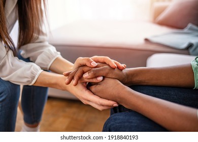 Different ethnicity female friends hold hands during confidential talk close up. Counsellor psychologist provide mental aid to patient at session in clinic, addicted patient professional help concept - Shutterstock ID 1918840193