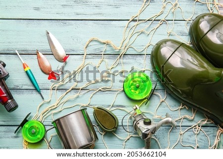 Different fishing equipment on color wooden background Foto stock © 