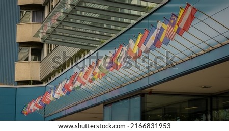 Different flags of all nations in the world collected standing in roe over a hotel entrance.