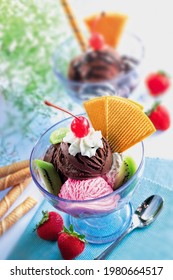 Different Flavor Ice Cream Sundaes On Light Blue Table Mat Background 