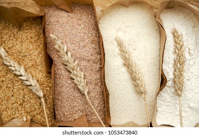 Different flour of wheat cereal in bakery bags.Texture of four wheat in mill:milled wheat sprouts, wheat bran,semolina flour,durum.Top view 
