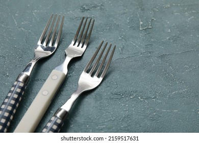 Different Forks On Grey Background, Closeup