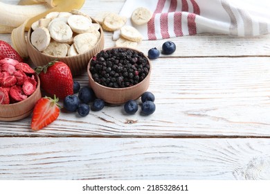 Different Freeze Dried And Fresh Fruits On White Wooden Table. Space For Text