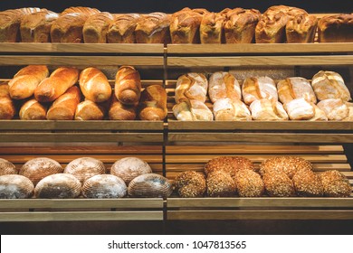 Different Fresh Bread On The Shelves In Bakery.