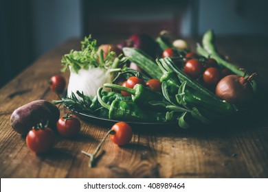 Different Fresh Farm Vegetables On Wooden Table. Autumn Harvest And Healthy Organic Food Concept. Toned Picture