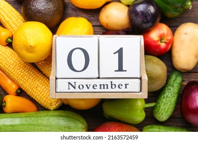 Different fresh fruits, vegetables and cube calendar with date NOVEMBER 1 on wooden background, closeup. World Vegan Day concept - Powered by Shutterstock