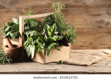 Different fresh herbs in basket on wooden table, space for text - Powered by Shutterstock