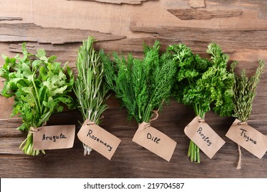 Different fresh herbs on wooden background - Powered by Shutterstock