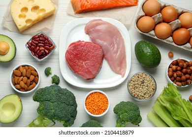 Different Fresh Products On White Wooden Table, Flat Lay. Sources Of Essential Amino Acids