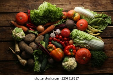 Different Fresh Ripe Vegetables On Wooden Table, Flat Lay. Farmer Produce