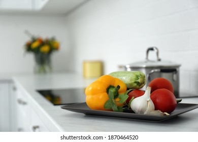 Different fresh vegetables on countertop in modern kitchen. Space for text - Powered by Shutterstock