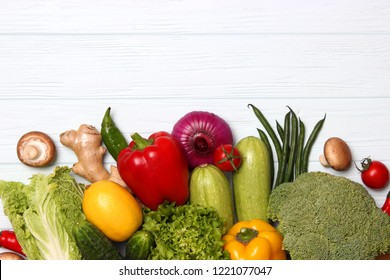 Different fresh vegetables on a wooden table top view. Proper and healthy food, diet, vegetarian. Cooking food, vegetable dishes. flat lay
