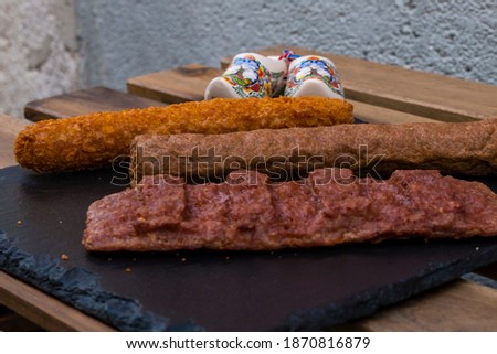 different fried meat. Different types of pork meat steak, chicken fillet and beef sausage with some sauces on dark wooden background. grilled and barbecue pork and beef sausages. American food.