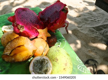 Different Fruit Of Bright Color: Mango, Fruit Dragon,
Passion Fruit , Carambola  On The Beach