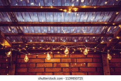 Different garden party lights on terrace transparent ceiling, micro leds and bulbs on string at night. - Powered by Shutterstock