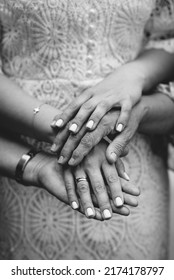 Different Generations: Daughter, Mother, Grandmother, Man And Grandfather. Focus On Hands. Unrecognizable Grandmother And Her Granddaughter Holding Hands. Close Up. Black And White Photo.