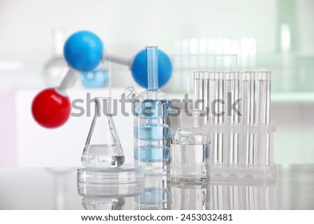 Different glassware and molecule model in laboratory