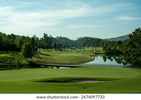 A different golf hole setup in the between of jungle, lake and mountians