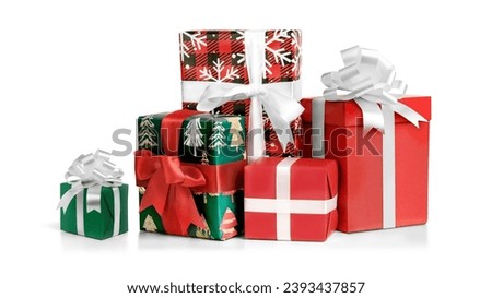Different green and red Christmas gift boxes stacked on a white background