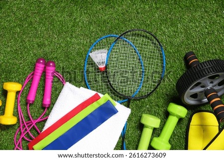 Different gym stuff on artificial green grass, flat lay