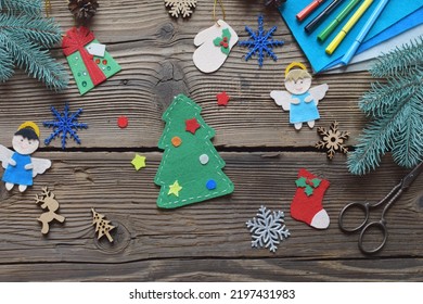 Different Handmade Christmas Toys From Felt With Your Own Hands On Wooden Background. New Years Childrens DIY Concept. Xmas Tree Decoration, Gift Or Greeting Card.