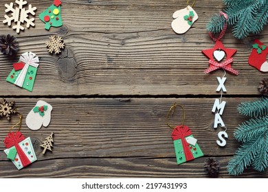 Different Handmade Christmas Toys From Felt With Your Own Hands On Wooden Background. New Years Childrens DIY Concept. Xmas Tree Decoration, Gift Or Greeting Card.