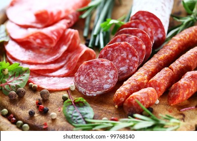 Different Italian ham and salami with herbs - Shutterstock ID 99768140