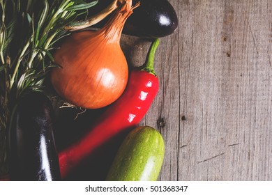 Different kind of local vegitables on the wooden rustic table. Organic food concept. Toned picture