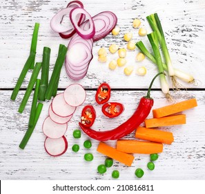 Different Kind Of Raw Vegetables On Wooden Table