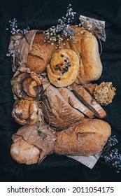 Different Kinds Of Bread And Baked Goods, Placed Into Box In Vintage Style Decorated With Dry Flowers.