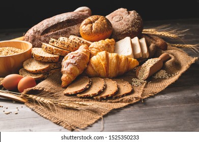 Different kinds of bread with nutrition whole grains on wooden background. Food and bakery in kitchen concept. Delicious breakfast gouemet and meal. Carbohydrate organic food cuisine homemade - Shutterstock ID 1525350233