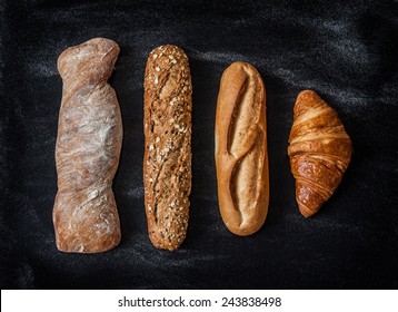 Different Kinds Of Bread Rolls On Black Chalkboard From Above. Kitchen Or Bakery Poster Design.