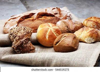 Different kinds of bread rolls on black board from above. Kitchen or bakery poster design. - Shutterstock ID 544519273