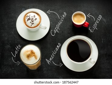 Different Kinds Of Coffee On Black Chalkboard Background. Cappuccino, Espresso, Americano And Latte From Above - Cafe Menu Or Poster.