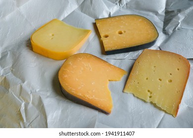 Different kinds of delicious cheeses on waxed wrapping paper. - Powered by Shutterstock