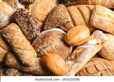 Different kinds of fresh bread as background, top view - Shutterstock ID 1416131036