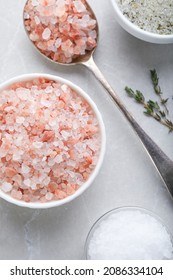 Different Kinds Of Salt On Light Grey Marble Table, Flat Lay