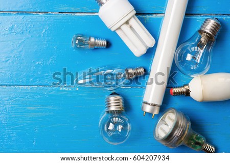different  Light bulbs  on wooden. Earth hour message card