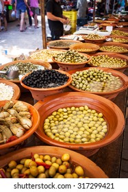 Different Marinated Olives And Local Food On Street Market In Mallorca, Spain. Selling And Buying.